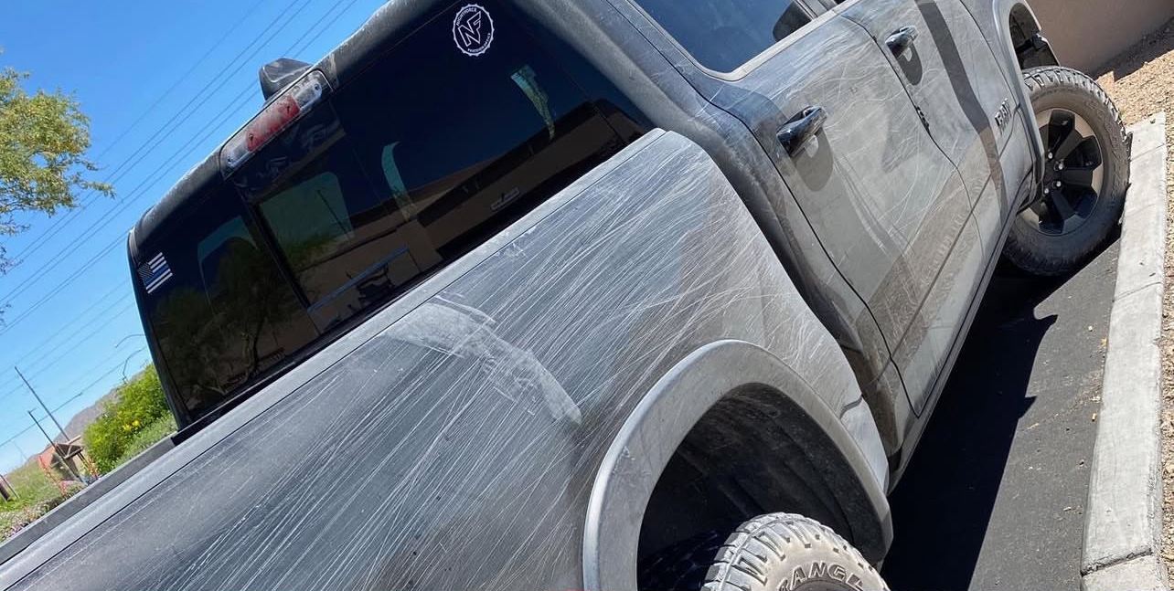 RAM 1500 Rebel before paint correction, swirls and scratches through the black paint